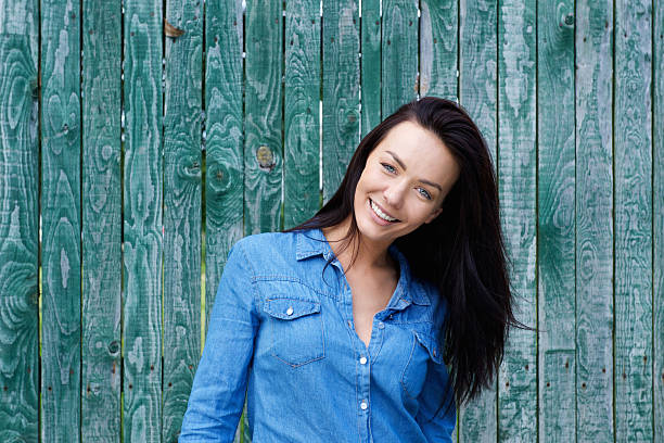istock Smiling brunette woman with blue shirt 506583164