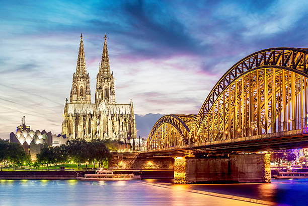 Illuminated Dom in Cologne Illuminated Dom in Cologne with bridge and rhine at sunset rhine river photos stock pictures, royalty-free photos & images