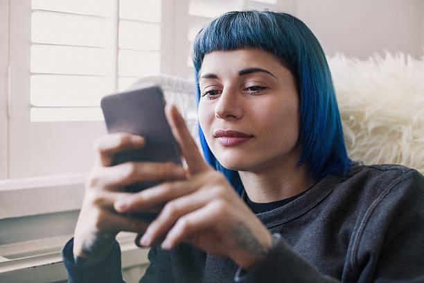 istock Young woman using smartphone at home 506583572