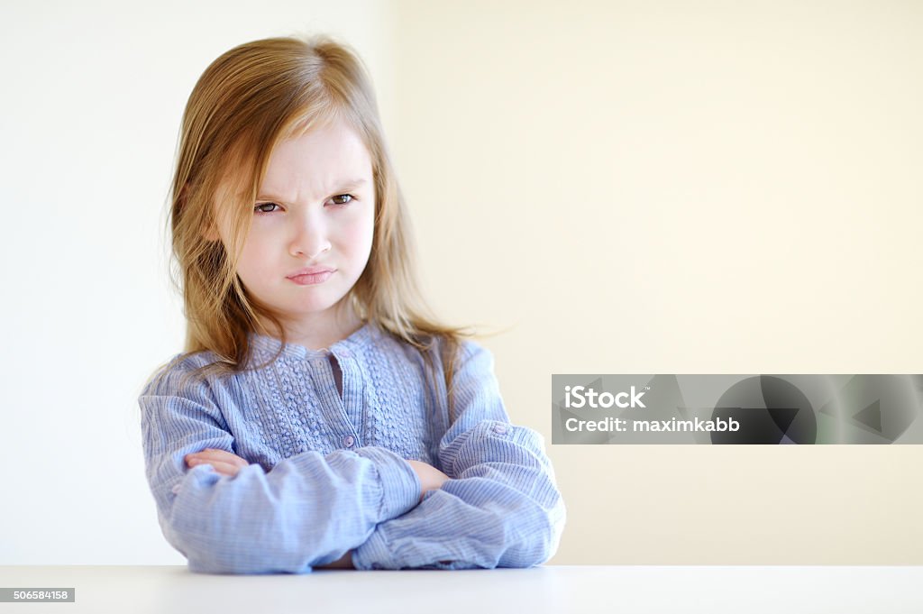 Portrait of a little angry girl Little angry girl portrait at home Girls Stock Photo