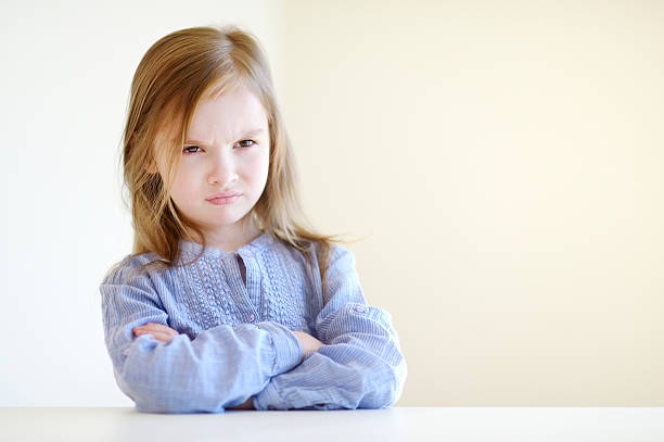 Portrait of a little angry girl Little angry girl portrait at home sulking stock pictures, royalty-free photos & images
