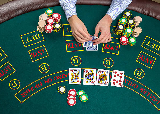 Closeup of poker player with playing cards and chips Close up of poker player with playing cards and chips at green casino table, view from above. texas hold em photos stock pictures, royalty-free photos & images