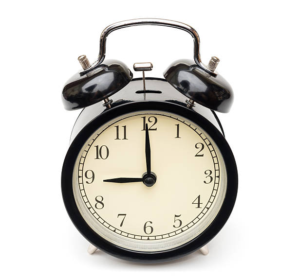 istock black alarm clock at nine isolated on white 506584842