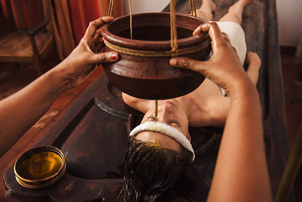 Ayurvedic shirodhara treatment in India Caucasian woman having Ayurveda shirodhara treatment in India kochi india stock pictures, royalty-free photos & images