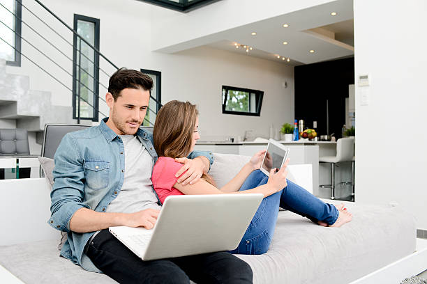 istock happy young couple relaxed sofa in beautiful modern design house 506586496