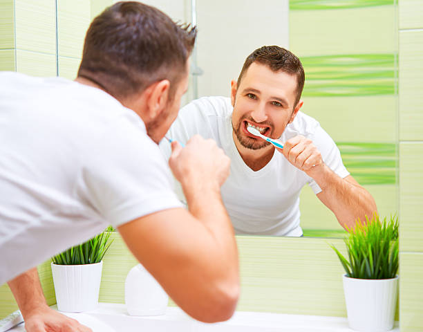 istock man brushing his teeth with toothbrush in morning 506587218