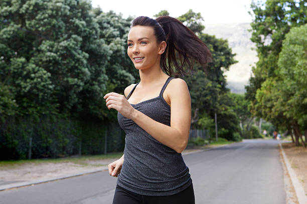 istock Fit young woman running outside 506587472