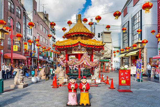 Chinatown, Kobe, Japan Kobe, Japan - December 17, 2015: Tourists enjoy the Nankinmachi Chinatown district of Kobe at the square and pavilion. It is one of three designated Chinatowns in Japan. motomachi kobe stock pictures, royalty-free photos & images