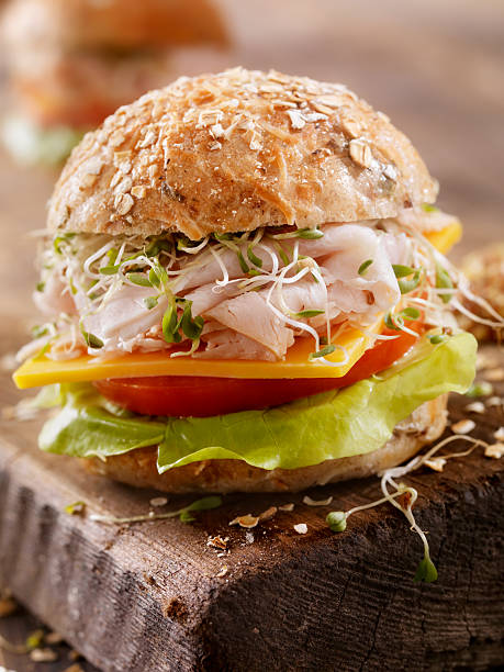 istock Turkey and Cheese Sandwich on a Rustic Cutting Board 506588294