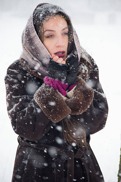 istock beautiful woman in snow 506588344