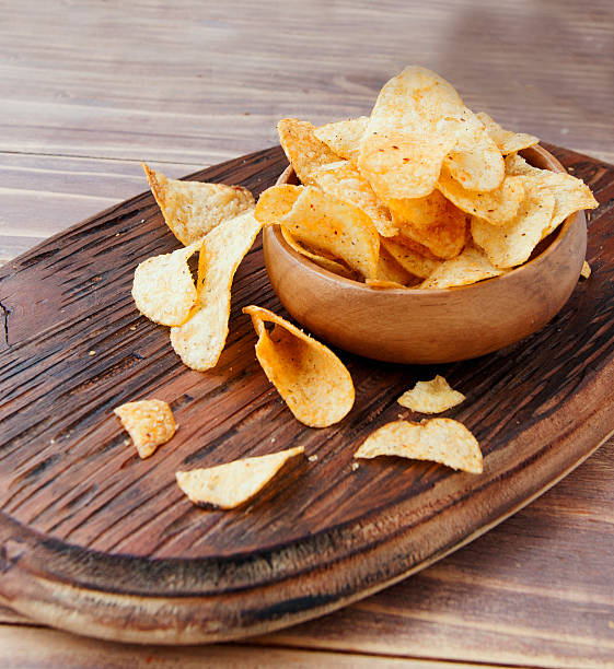 istock Chips in a wooden bowl on table 506591876