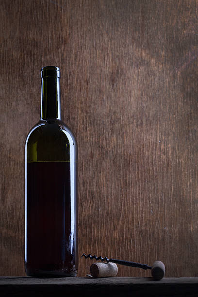 istock wine bottle on a background of old wood 506592124