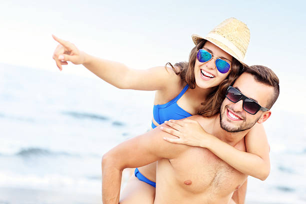 istock Young couple pointing  something at the beach 506592594