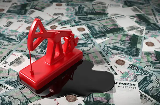 Photo of Pumpjack And Spilled Oil On Russian Rubles