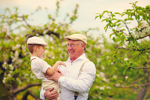 istock grandfather with grandson having fun in spring garden 506593498