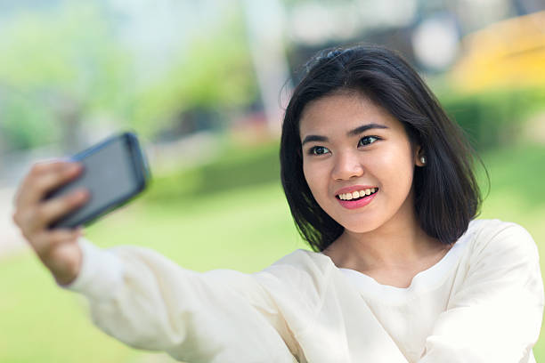 istock Young woman taking a selfie 506593528