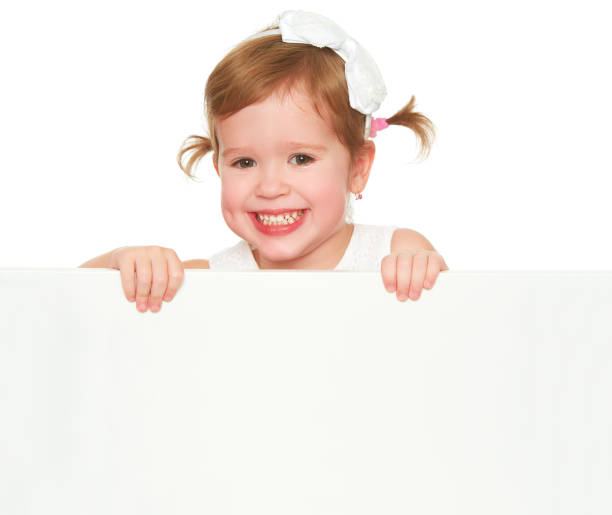 istock concept child girl with white blank poster isolated 506593902