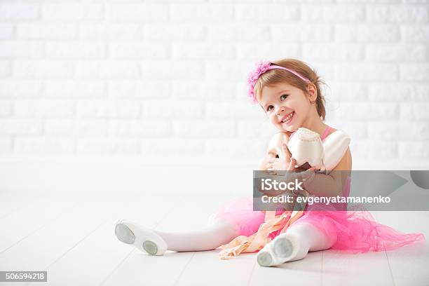 Little Child Girl Dreams Of Becoming Ballerina With Ballet Shoe Stock Photo - Download Image Now