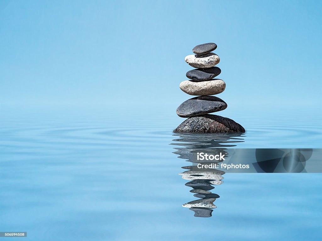 Zen balanced stones stack Zen harmony meditation relaxation peacefulness peace of mind concept background -  balanced stones stack in water with reflection Rock Cairn Stock Photo