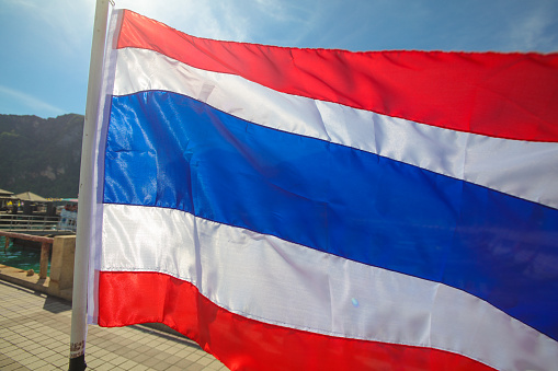 Thailand flag against on Koh Phi Phi Don.