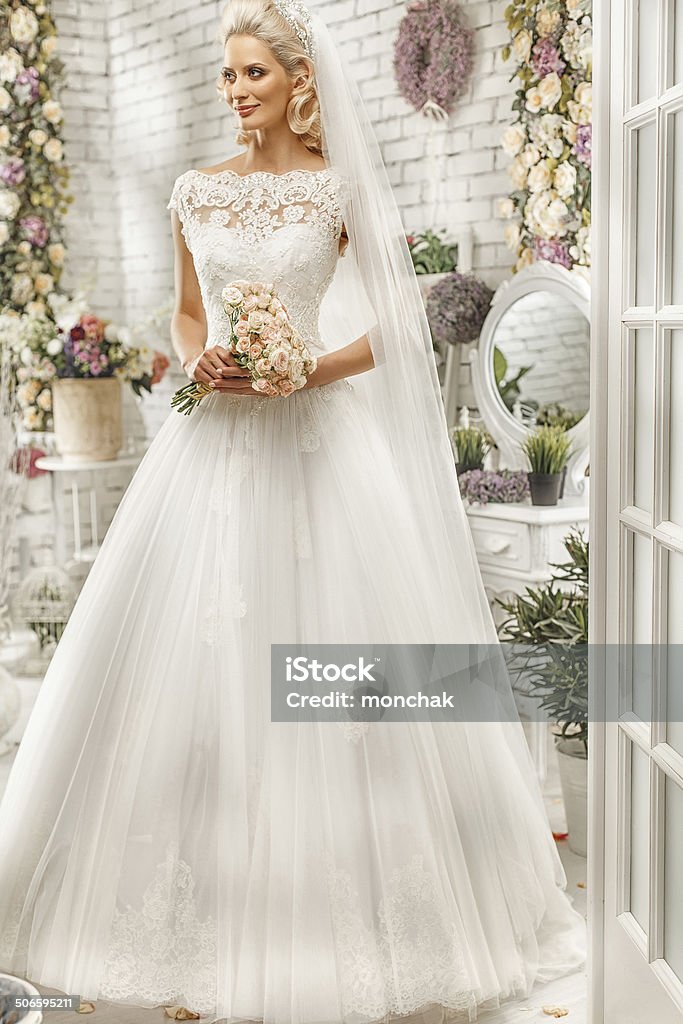 The beautiful  woman posing in a wedding dress Adult Stock Photo