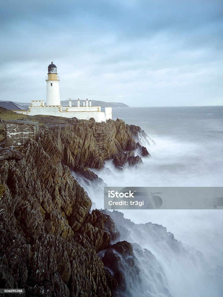 Long Exposure Storm Sea Lighthouse Cliffs Long Exposure of a Stormy Sea with Lighthouse on top of Rocky Cliffs. Location, Douglas,  Isle of Man, United Kingdom Isle of Man Stock Photo