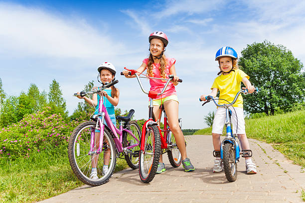 istock Three girls on a pave road with bicycles 506595511