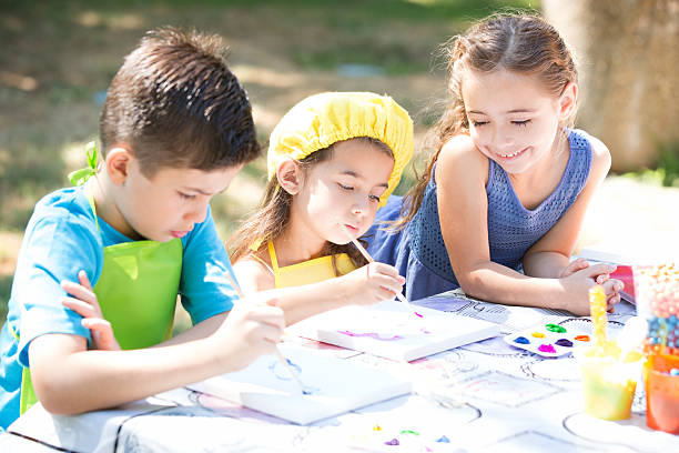 istock Three Children Painting 506595626