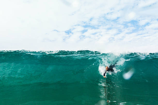bodysurfing bodysurfer on a hollow, green wave bodysurf stock pictures, royalty-free photos & images
