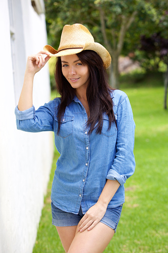 Portrait of a cool confident young woman with cowboy hat