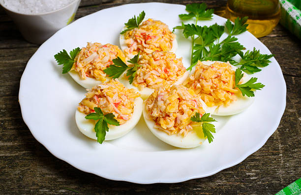 istock Eggs stuffed with crab and cheese on a wooden table 506596158