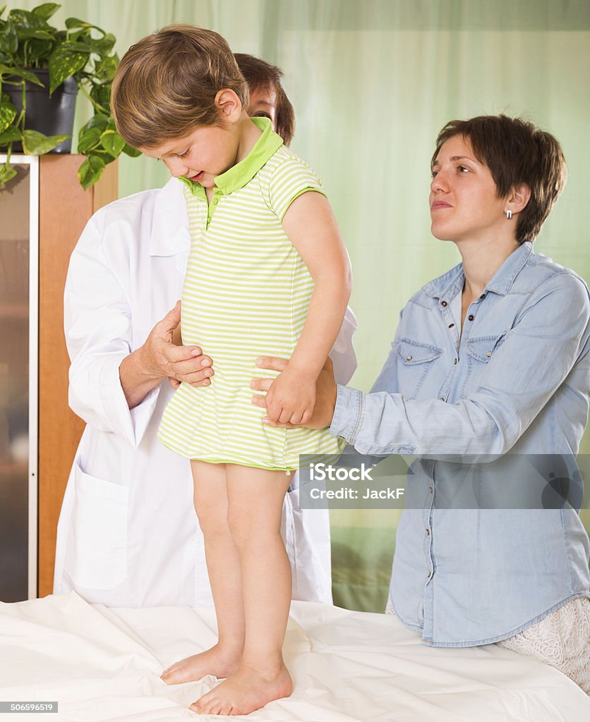 Doctor examining child Friendly old female pediatrician doctor examining small patient at clinic 2-3 Years Stock Photo