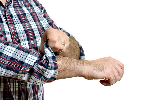 Man rolls up sleeves stock photo