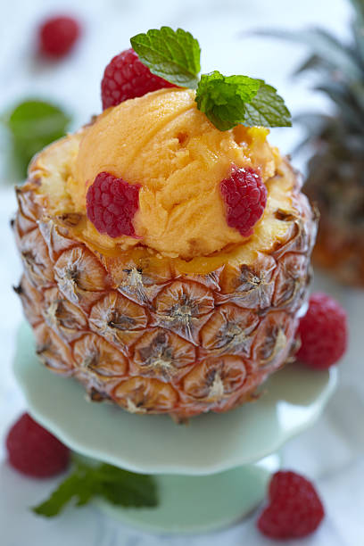 istock Fruit sorbet ice cream in small pineapple 506599087