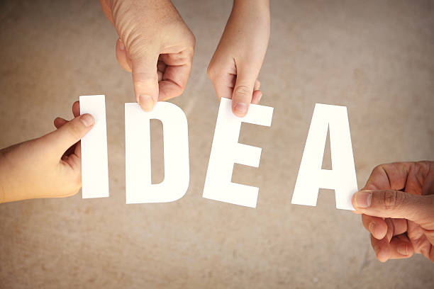 istock Idea - Hands Holding White Letters Over Grunge Background 506599191