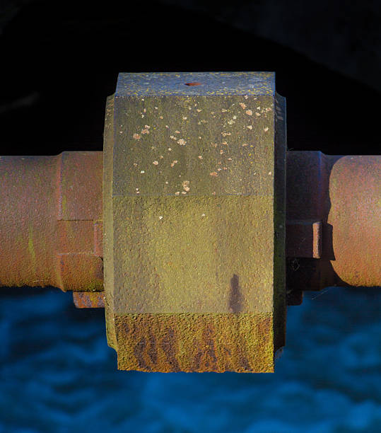 istock Rusted water pipe over water stream 506599972