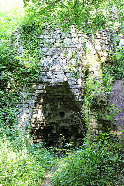 istock Image of old stone lime kiln in woodland, quicklime calcination 506600951