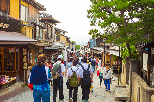 Kyoto, Japan - June 17, 2015: Crowded tourist shopping street Matsubara-dori full of shops and restaurants at base of Kiyomizu-dera in Kyoto, Japan
