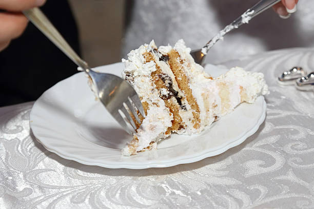 the bride and groom eating wedding cake