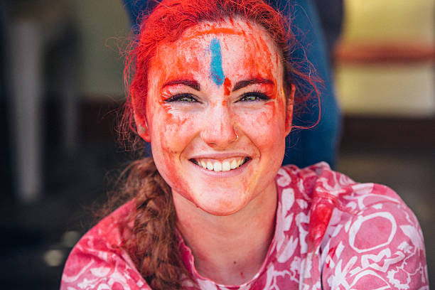 Young woman celebrating Holi Day.