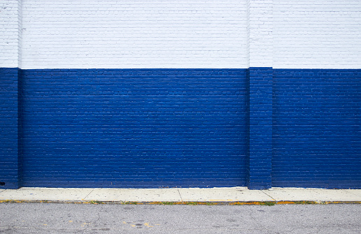 Painted on blue brick wall on the street