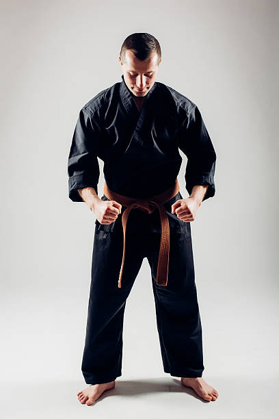 istock Young male with orange belt karate fighter training. 506608326