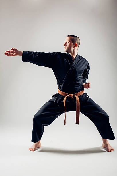 istock Young male with orange belt karate fighter training. 506608442