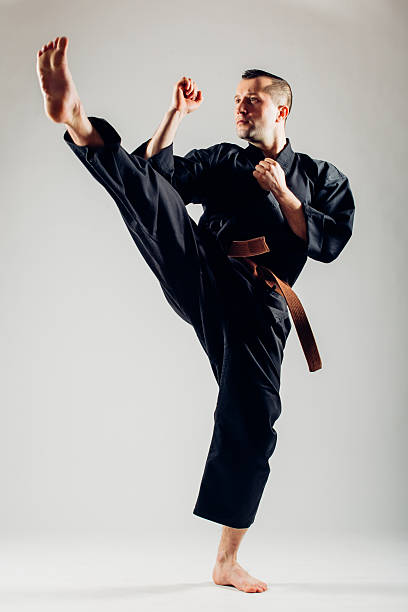 istock Young male with orange belt karate fighter training. 506608838