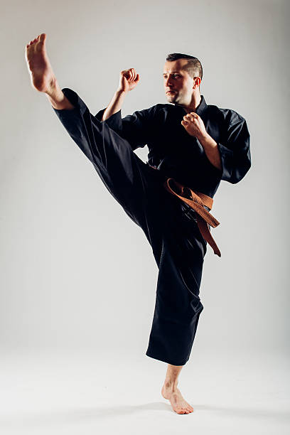 istock Young male with orange belt karate fighter training. 506608870