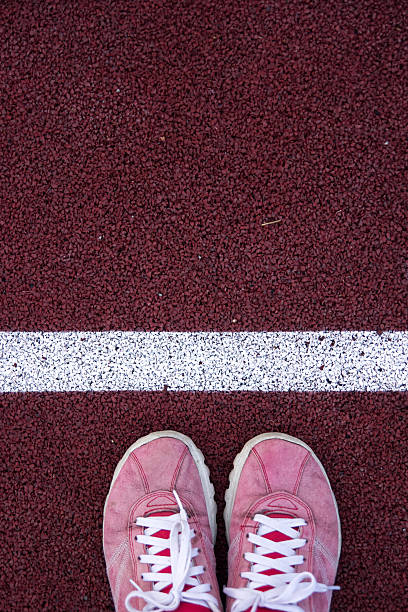 istock Top view of shoes on running track 506611366