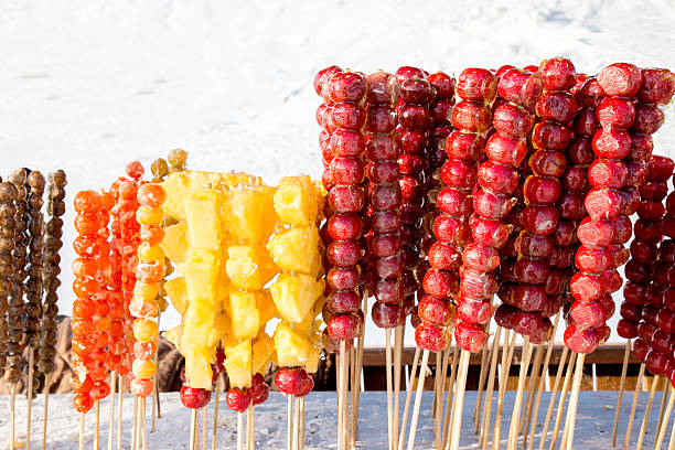 istock Frozen sugar coated red and yellow fruits on sticks 506612696