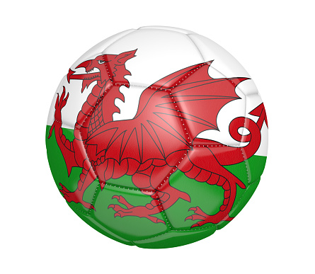 Realistic sports item render of a football, also known as a soccer ball, painted with the Welsh national flag, and isolated over a white background.