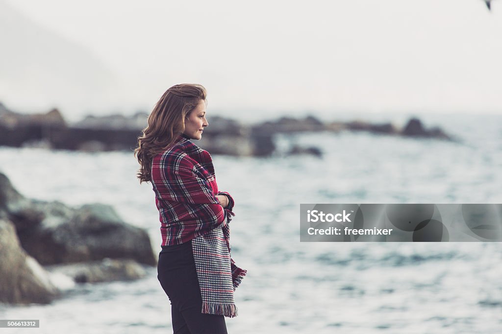Enjoying my winter break Woman enjoying in view at sea side Adult Stock Photo