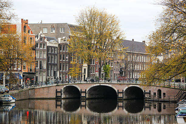 Amsterdam, Netherlands - November 5, 2011: The Torensluis bridge over the Singel canal, as seen from the Raadhuisstraat bridge in Amsterdam.